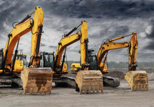 powerful-excavators-construction-site-against-blue-cloudy-sky-earthmoving-construction-equipment-lots-excavators